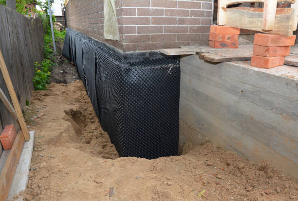 Happy homeowners after waterproofing job in Viola